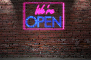 Obraz premium Leuchtreklame We’re Open an Ziegelsteinmauer