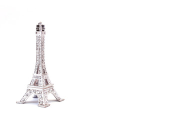 Fototapeta na wymiar Toy Eiffel Tower on a white background. Isolated