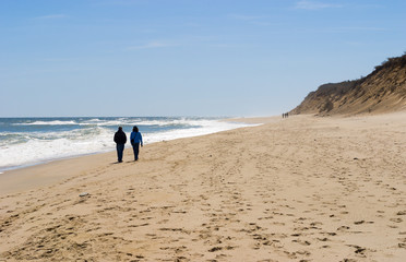 couple walking along seashore at Cape Cod