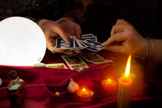 Tarot cards in hands of old gypsy fortune teller