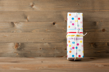 Polka dot gift box on wooden table