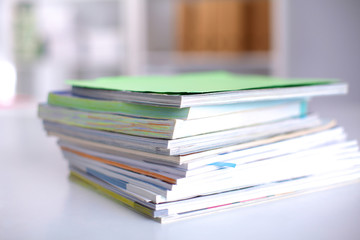 close up of stack of papers on white background
