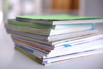 close up of stack of papers on white background