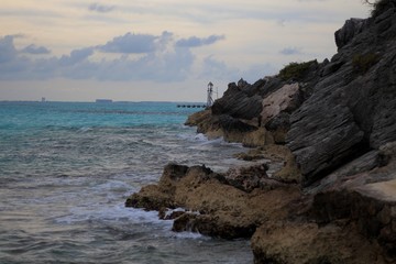 Fototapeta na wymiar Caribbean Sea meets rocky shore of Isla Mujeres, Mexico.