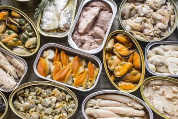 Foto op Plexiglas Assortment of cans of canned with different types of fish and seafood © dulsita