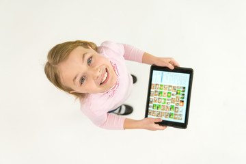 The happy girl stand with a tablet. View from above