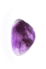 Close up purple gem or crystal isolated with white background