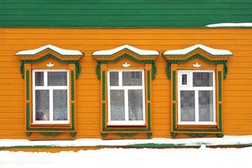 Three of wooden windows on a yellow background