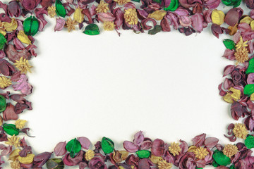 Dried flowers and leaves composition frame on white background. Top view, flat lay. Copy space for text or image