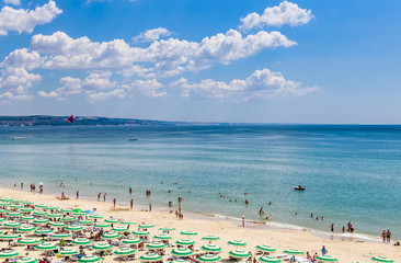 The Black Sea shore, blue clear water, beach with sand, umbrellas and sunbeds. Albena, Bulgaria