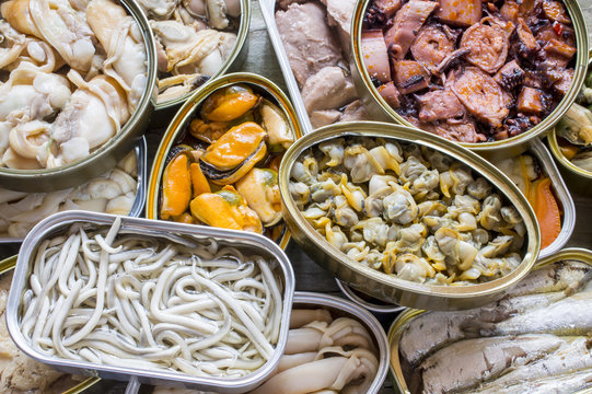 Assortment of cans of canned with different types of fish and seafood