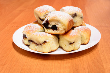 Czech baked buns with jam and sugar. Baking cakes. Traditional Czech recipe for buns. Festive delicacies. Buns on a plate.