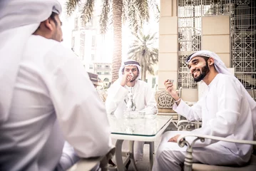 Türaufkleber arabic business men spending time in Dubai © oneinchpunch