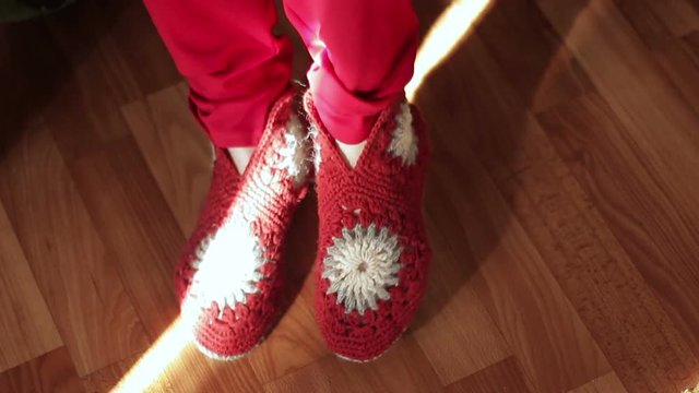 Woman putting on a red hand-made shoes.Close up