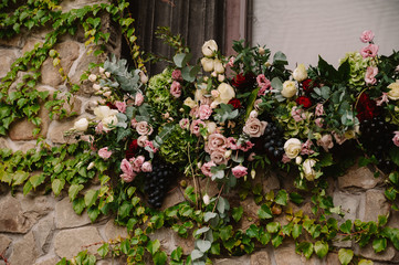 Wedding floral composition on the stone wall