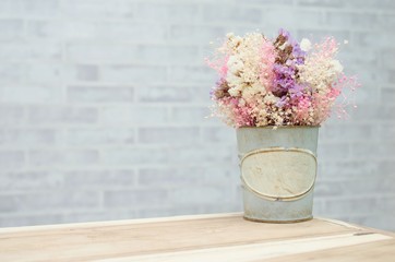 flower in retro vintage vase on wooden table with wall background, retro vintage concept with copy space for text.