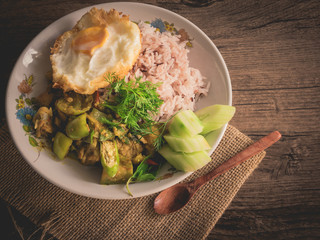 Vintage style Thai - Indian traditional food chicken green curry hot chili spicy with omelette on wooden background