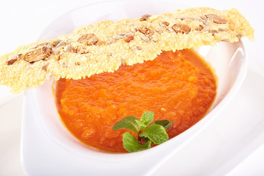 Tomato cream soup in white plate