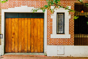 Wooden gate with window at the entrance of a house