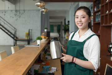 Fototapeta na wymiar young pretty woman works in cafe