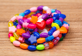 suspension of colored beads lying on wood