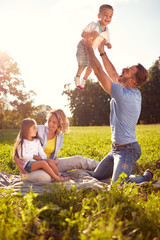 Parents have fun with children on picnic