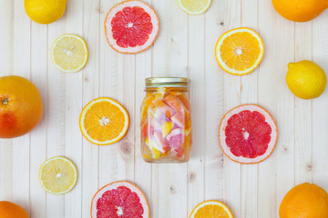 Fresh lemonade in a jar with slices of grapefruit, orange, lemon.