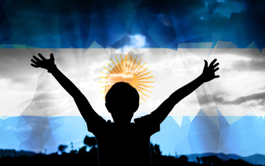 Young man raising his hands on a sunset background with a flag background - 139371150