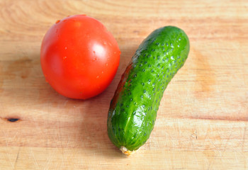 Green cucumber and red tomato.