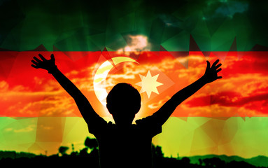 Young man raising his hands on a sunset background with a flag background - 139371399