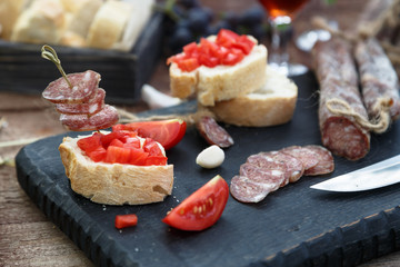 Tapas topped tomato and sausage