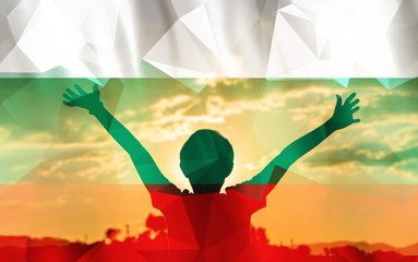 Young man raising his hands on a sunset background with a flag background - 139371986
