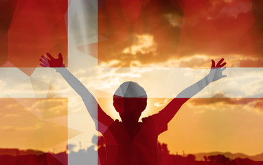 Young man raising his hands on a sunset background with a flag background - 139372153