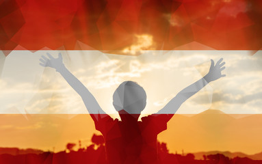 Young man raising his hands on a sunset background with a flag background - 139373197