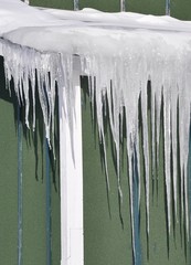 Sharp icicles on the edge of the roof