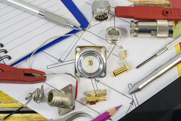 Part of electrical engineering project with components,  notes and tools on the yellow and brown wooden background