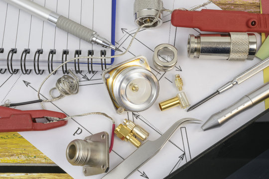 Part of electrical engineering project with components,  notes and tools on the yellow and brown wooden background