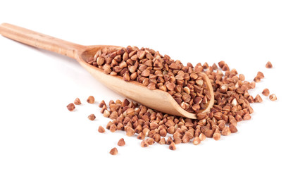 buckwheat in the wooden scoop isolated on white background