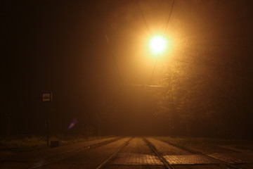 Night lamp light on the tram, train stop.