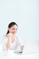 young pretty woman using laptop in office