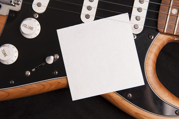 Blank paper with electric guitar. Use for music application or poster.