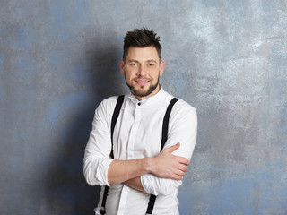 Handsome young man posing on gray background