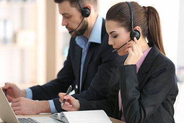 Young woman with headset working in office © Africa Studio