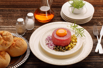 Beef tatare with egg, onion, cucumber and capers