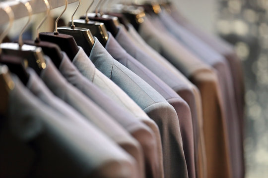 Row Of Men's Suits Hanging On Hanger
