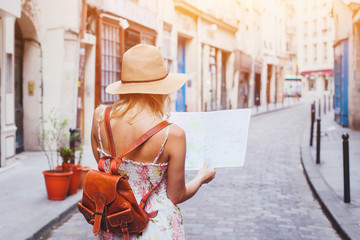 woman tourist looking at the map on the street of european city, travel to Europe