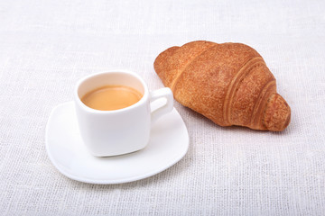 Cup of espresso coffee on white plate with pieces cookie on white background