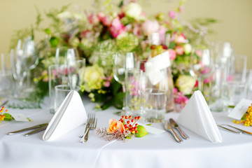 Beautiful table setting with crockery and flowers for a party, wedding reception or other festive event