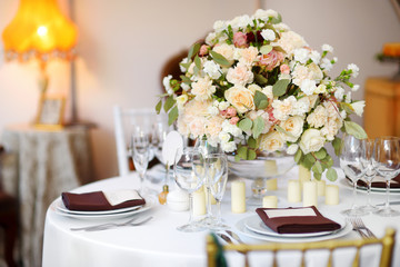 Beautiful table setting with crockery and flowers for a party, wedding reception or other festive event