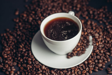 a cup with a drink, coffee beans, a pleasant aroma